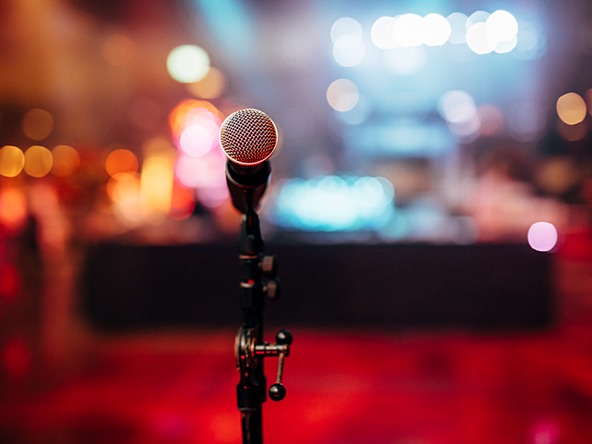 microphone on a stage with blurry lights behind it